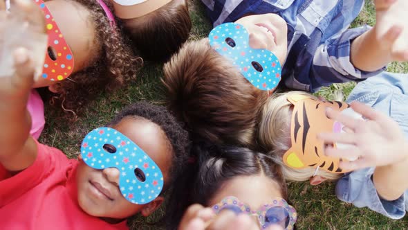 Happy friends gesturing while lying on grass 4k