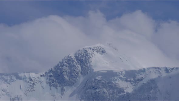 Timelapse of the Two Peaks of the Russian Mountain Belukha in the Clouds Floating in the Sky