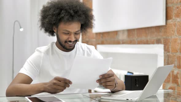 Excited African Man Reading Contract, Cheering Success