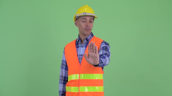 Serious Multi Ethnic Man Construction Worker with Stop Gesture