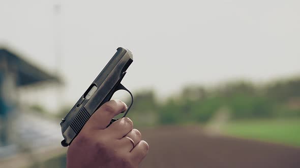 Slow Motion Close-up Starting Pistol Gun in Hand Makes Shot To Start Track and Field Races at