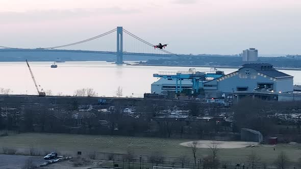 An aerial view over Calvert Vaux Park in Brooklyn, NY during a cloudy evening. The drone camera pan