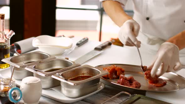 Hands Taking Meat From Liquid.