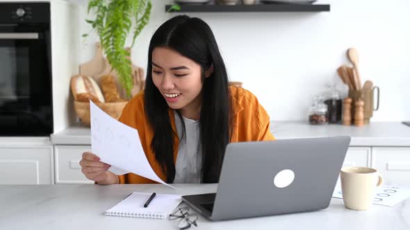 Amazed Asian Girl in Stylish Casual Clothes Freelancer IT Specialist Sitting at Table with Laptop in