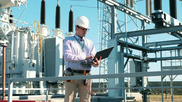 Outdoors Power Station is Being Checked By a Safety Inspector