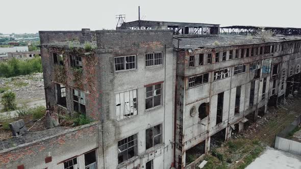 Aerial view from the air to an abandoned factory. Old industrial building for demolition.