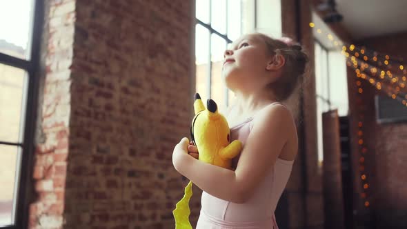 Beautiful Little Child Girl Hugging Soft Toy Yellow