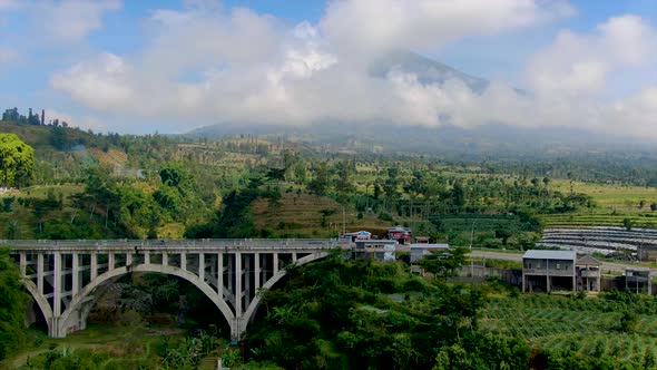 Concrete Sigandul Bridge and Mount Sumbing in Central Java aerial panorama