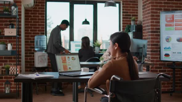 Asian Woman Answering Landline Phone Ringing in Workplace