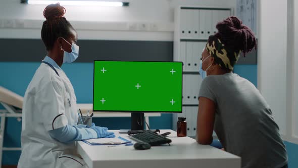 Patient and Medic Looking at Horizontal Green Screen on Monitor