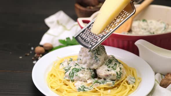 Portion of Delicious Meatballs with Spinach in a Creamy Sauce