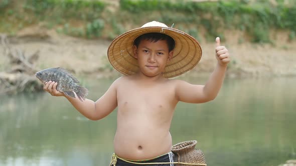 Boy Holding Fish And Thump Up