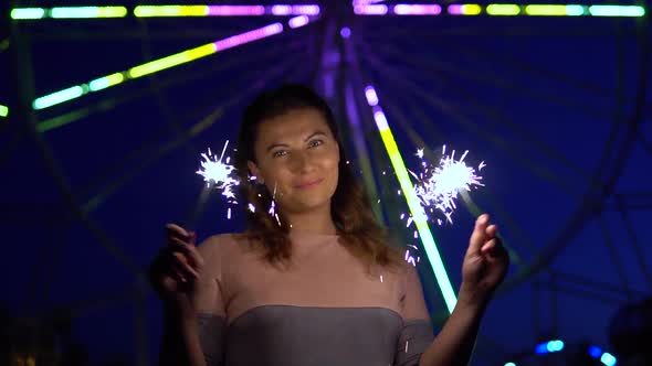 An Attractive Girl is Happy with a Holiday with Fireworks in Her Hands