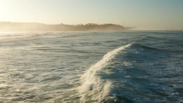 Following large waves at sunrise