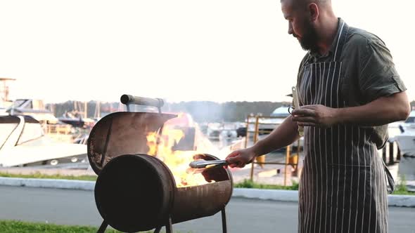 Barbecue outside. Picnic Party with roast beef on background of yachts