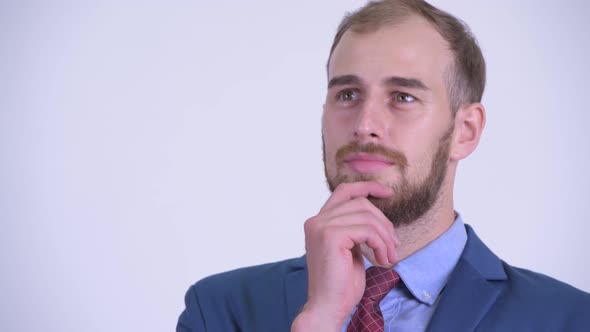 Face of Happy Bearded Businessman Thinking and Looking Up