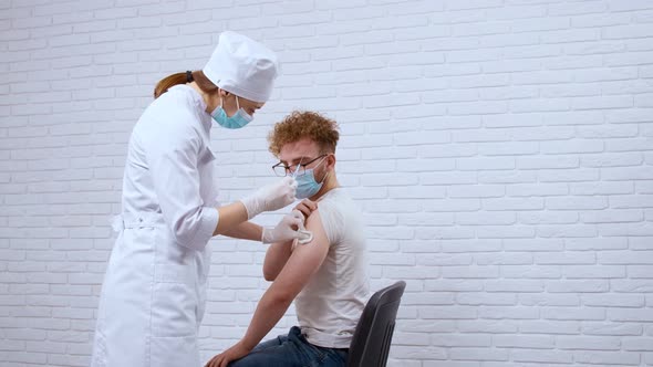 Nurse Giving Injection Vaccine Covid2019 for Young Man