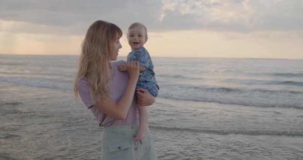 Mother and Her Toddler Son Have Fun at the Beach