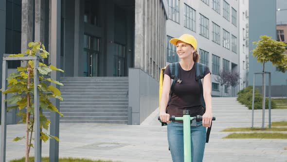 Portrait Shot of Young Delivery Woman with Thermo Bag or Backpack Riding a