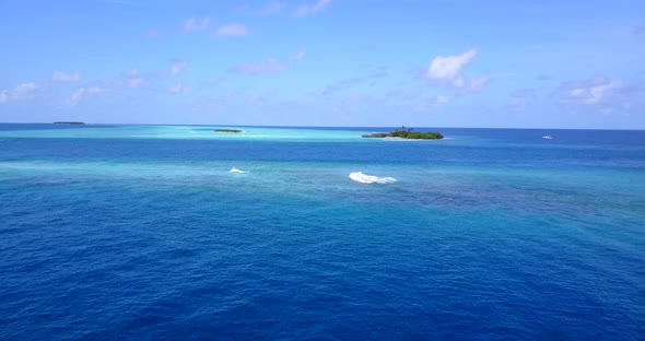 Luxury fly over abstract view of a white paradise beach and aqua blue ocean background in 4K