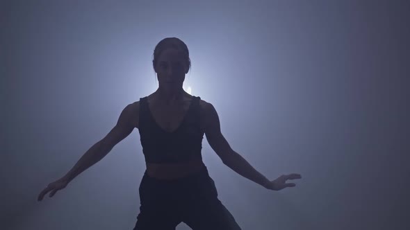 Silhouette of Woman Performing Contemp Choreography Moves