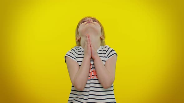 Child Girl Sincerely Praying to God and Looking Up with Pleading Expression Begging Apology Help