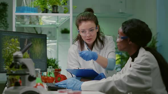 Two Collegues Checking Sample of Vegan Meat Writing Biotechnology Expertise