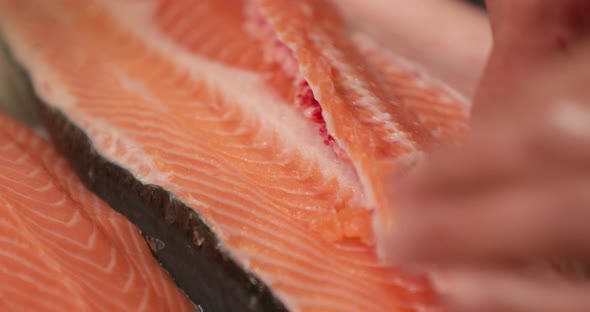 Deboning Raw Salmon For Sushi - close up, slow motion