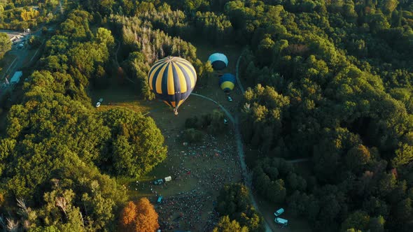 Aerial View of Hot Air Balloon Takes Off in the Park During the Festival. Beautiful Sky and Sunset