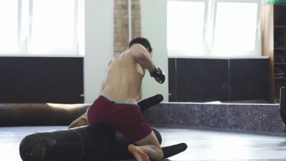 Professional Mma Fighter Practicing Grappling and Punching at the Gym