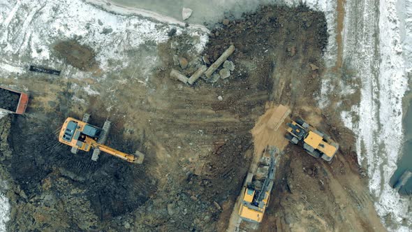 Industrial Machinery Working at a Construction Site. Working Tractors Dig Earth at a Career.