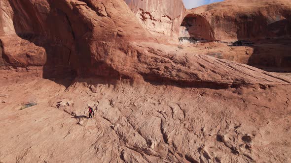 Aerial  of a woman hiking through the landscape near Moab