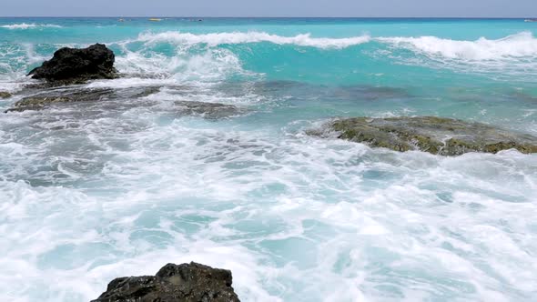 Sea waves breaking onto rock