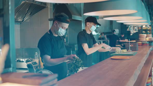 Restaurant Workers are Cooking Food in Face Masks