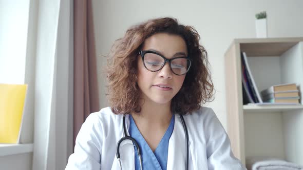 Attractive Female Doctor Wear Eyeglasses Make Online Video Call Consult Patient