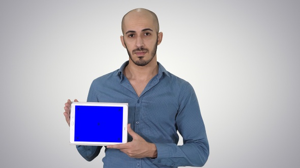 Arab Man Showing Blank Tablet Screen on Gradient Background