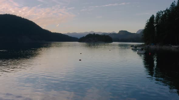 Rocky Shore Of Sechelt Inlet With A Calm Water On A Summer Sunset - A Pacific Ocean fjord On The Sun