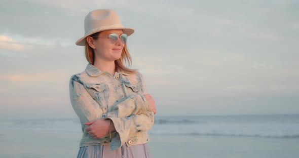 Young Woman Feeling Happy and Inspiration While Contemplating Sunset Over Ocean