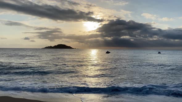 sea at golden dawn with a small island on the horizon