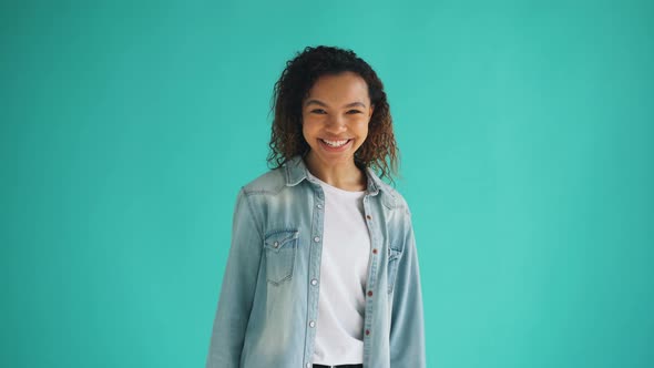 Portrait of Cheerful African American Woman Turning To Camera and Laughing