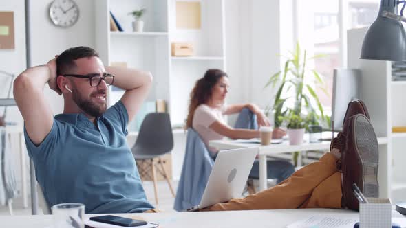 Caucasian Bearded Businessman Having Rest at Workplace