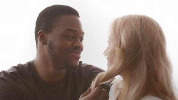 Loving African American Husband Touching Wife's Hair Talking Flirting Indoors