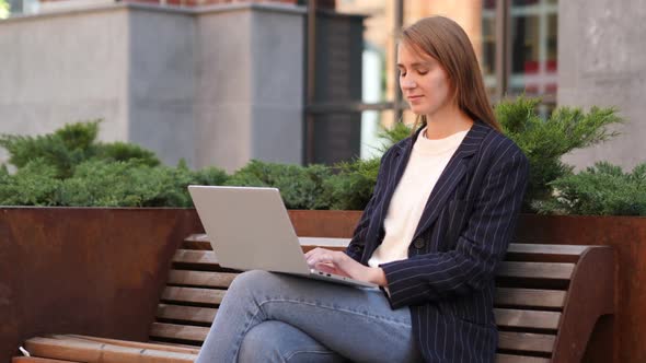 Business Woman Leaving After Sitting on Bench and Working on Laptop