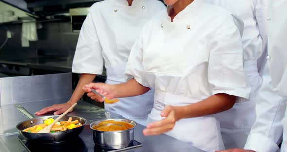 Team of chefs tasting food in the kitchen