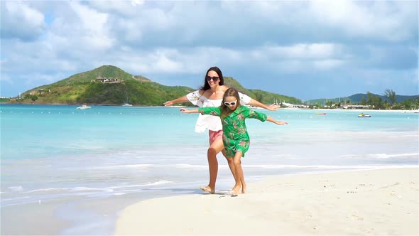 Beautiful Mother and Daughter on Caribbean Beach. SLOW MOTION