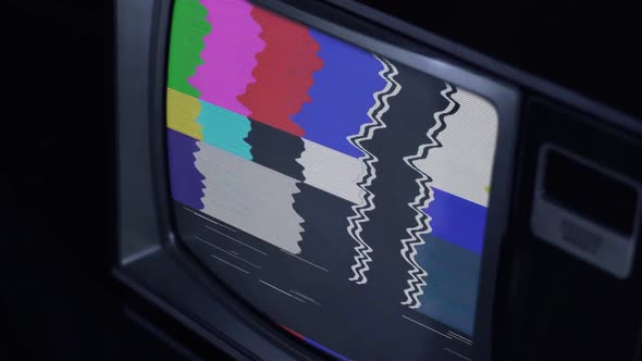 An Old Television Set with Color Bars and Bad Signal.