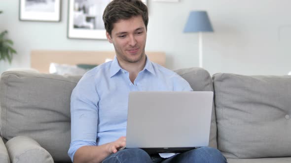 Online Video Chat on Laptop by Young Man