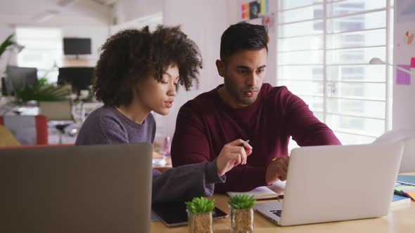 Two colleagues working in creative office