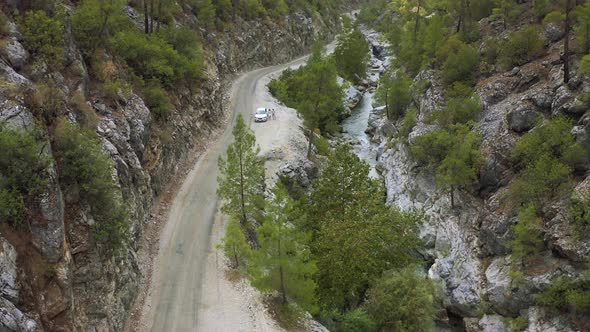A Young Couple of Tourists Travel By Car Through a Mountain Gorge in Turkey