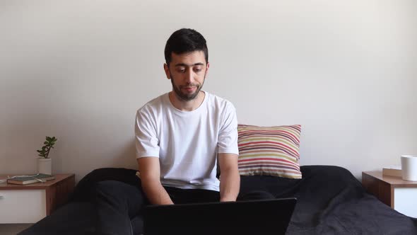 Annoying and tired young man working from home with no enthusiasm.